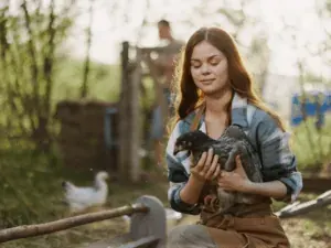 Filhote no colo de uma mulher em ambiente de campo